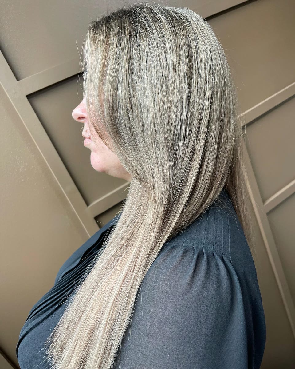 Long, straight ash-blonde hair with fine highlights, seen in profile
