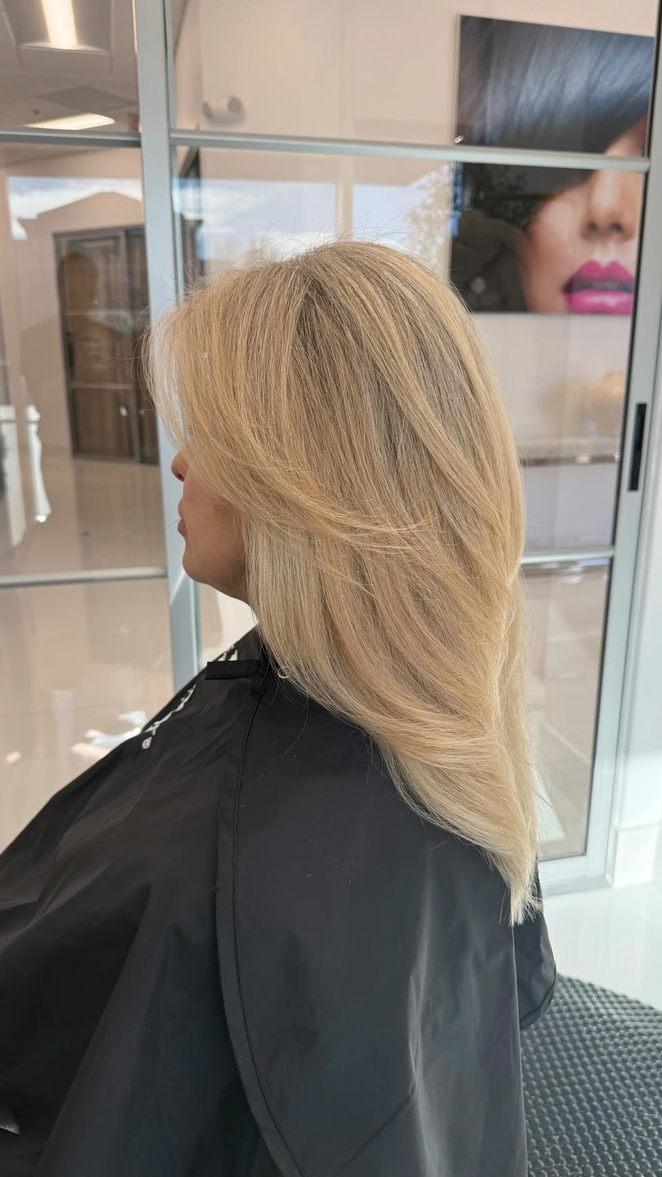 Long, layered light golden-blonde hair, seen in profile