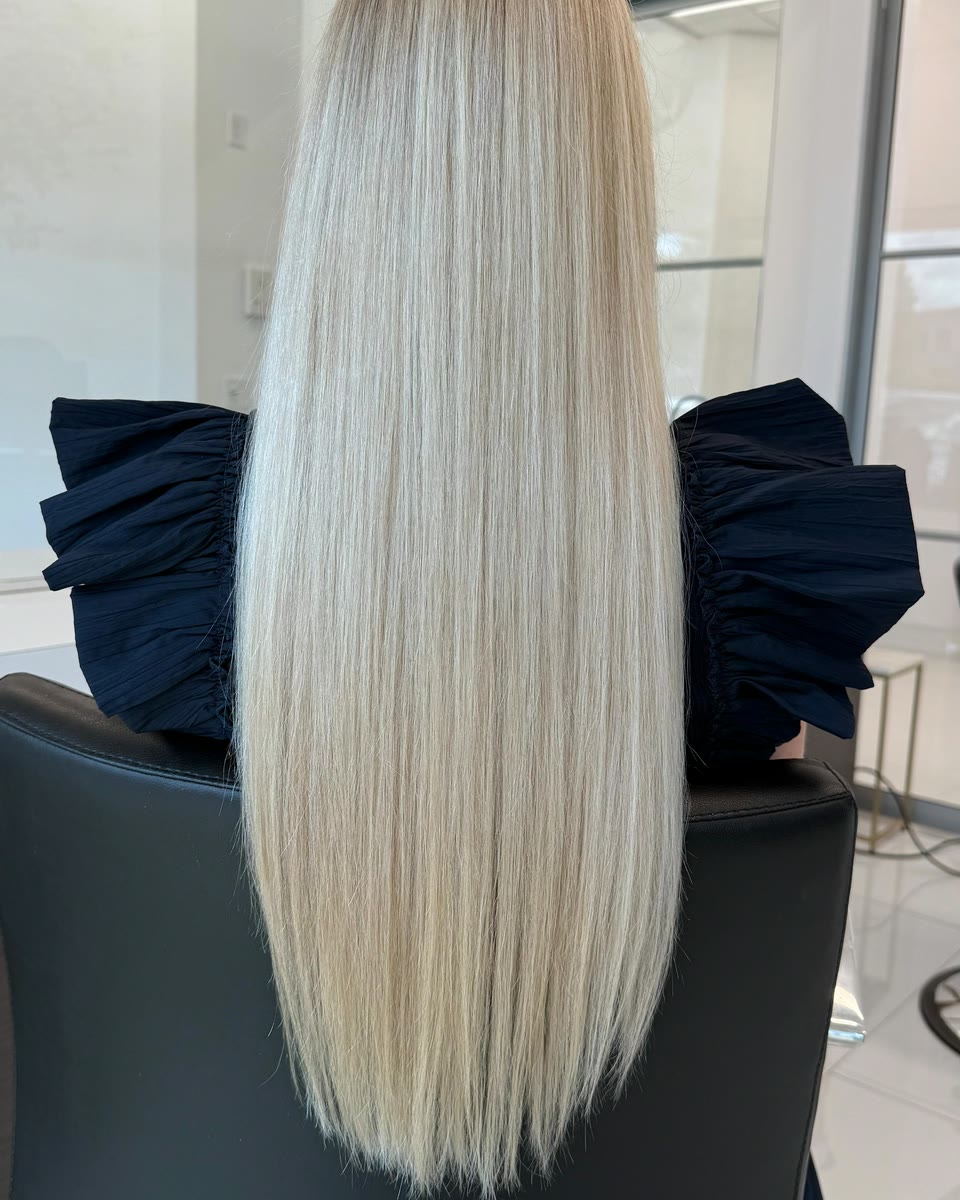 Very long, straight platinum-blonde hair, seen from behind